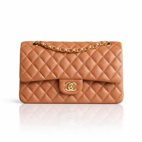 This iconic Chanel Classic Double Flap bag features luxurious caramel lambskin leather with the signature diamond quilting pattern. The bag showcases the timeless interwoven gold-tone chain strap and the distinctive CC turn-lock closure on the flap. This medium-sized classic flap offers elegant versatility with its double interior compartments, embodying Chanel’s legendary craftsmanship and enduring sophistication.  Follow this item for alerts. Chanel is a registered trademark of Chanel. We are not affiliated with Chanel.  Condition: Excellent